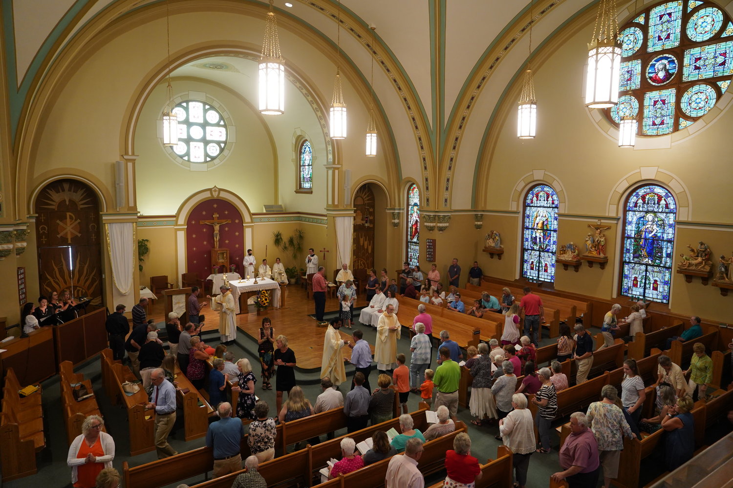 People come forward to receive Holy Communion at Mass in St. Pius X Church in Moberly in August 2021.
